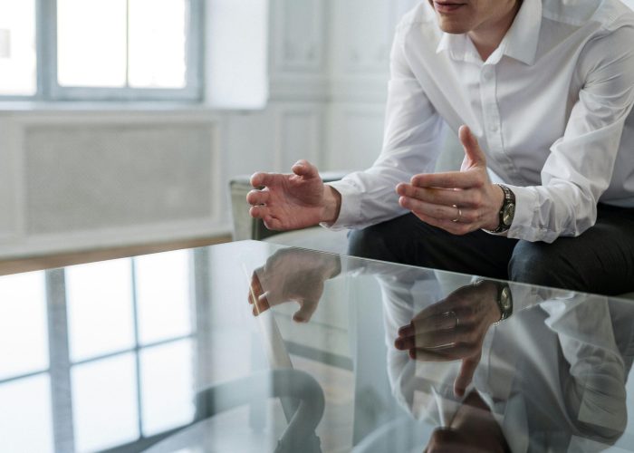 Professional consultant discussing solutions during a meeting indoors.